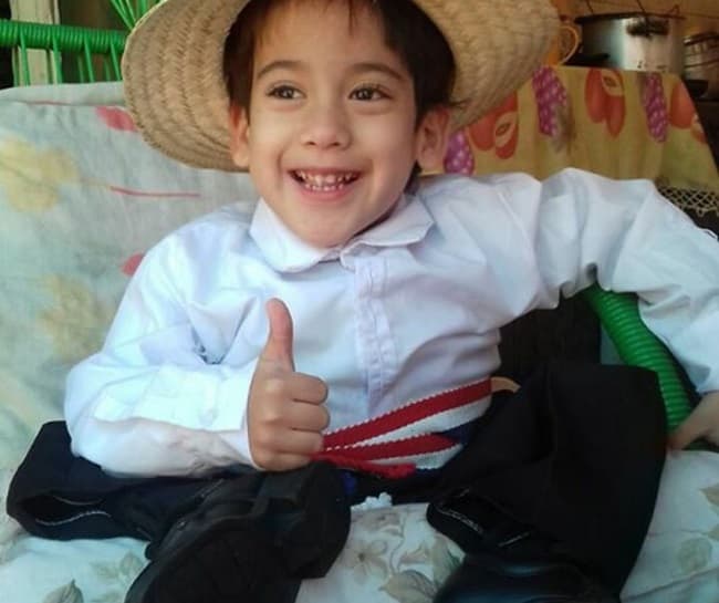 Niño en silla de ruedas ayuda a su madre y conmueve en redes